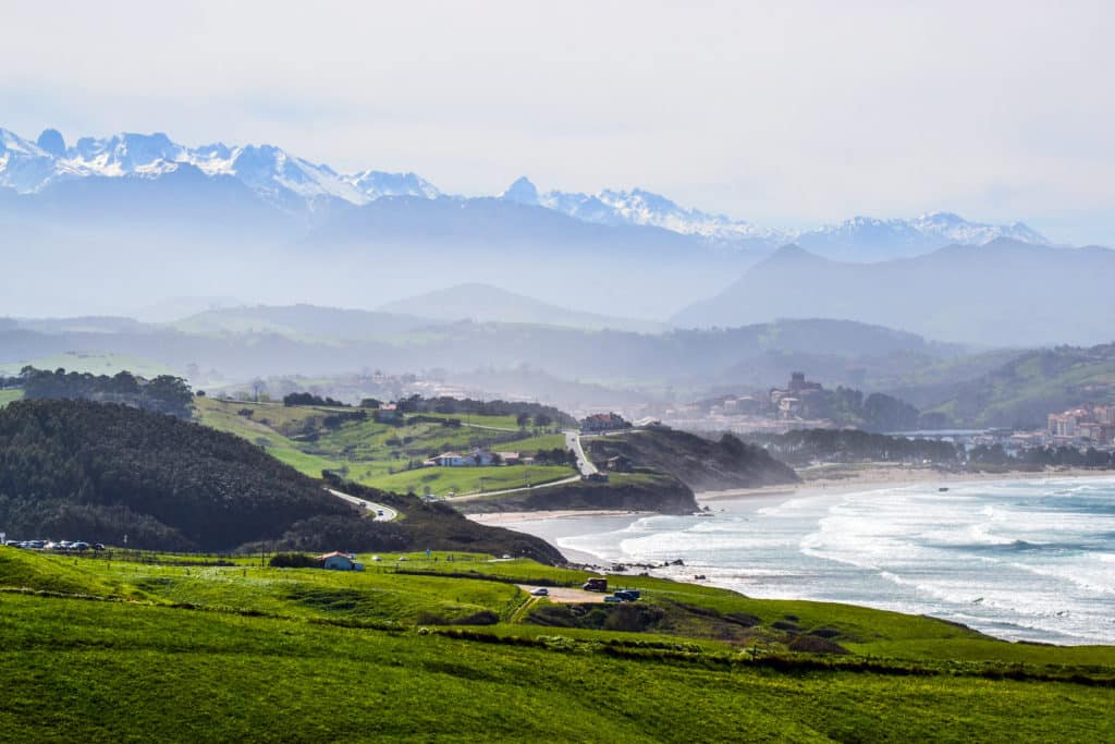 Landscape near Oyambre Beach, in San Vicente de la Barquera, Cantabria, Spain. At the bottom, the Picos de Europa Mountains