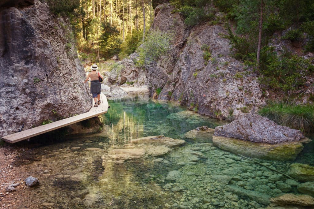 Woman walking by the Parrizal in Beceite, nature reserve, Matarrana river, Teruel, Aragon, Spain